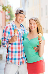 Image showing smiling couple with ice-cream in city