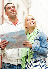 Image showing happy couple with map exploring city