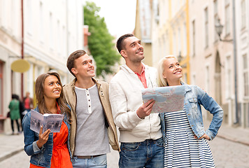 Image showing group of smiling friends with city guide and map