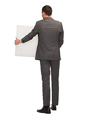 Image showing businessman or teacher with white board from back