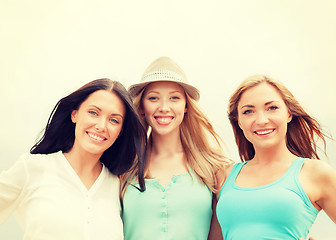 Image showing group of smiling girls chilling on the beach