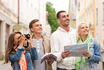 Image showing group of friends with city guide, map and camera