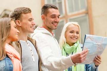 Image showing group of friends with map exploring city