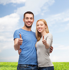 Image showing smiling couple showing thumbs up