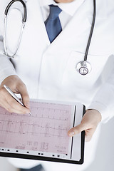 Image showing male doctor hands with cardiogram