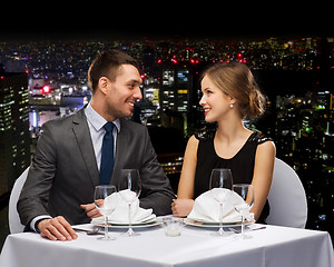 Image showing smiling couple looking at each other at restaurant