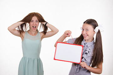 Image showing Teacher in horror, student with a sign