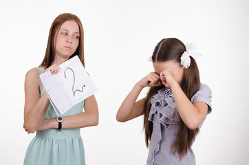 Image showing Schoolgirl crying upset because of two received