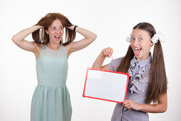 Image showing Teacher in horror looking at the student with a sign