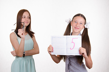 Image showing teacher looks at joy of student from resulting five