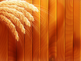 Image showing Wheat on wooden autumn background. EPS 10