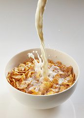 Image showing milk pouring into bowl with corn flakes