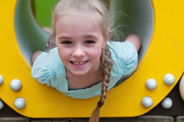 Image showing Adorable young girl sitting in crawl tube