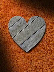 Image showing Weathered gray wood heart against rusty metal background