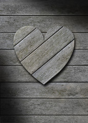 Image showing Gray weathered wood heart on wooden background