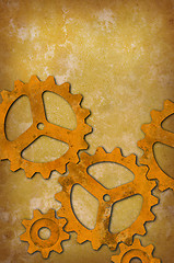 Image showing Rusty gears against a mottled yellowish background