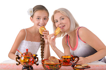 Image showing Mother and daughter eating pies