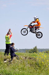 Image showing The motorcyclist on the motorcycle participates in race on a cro