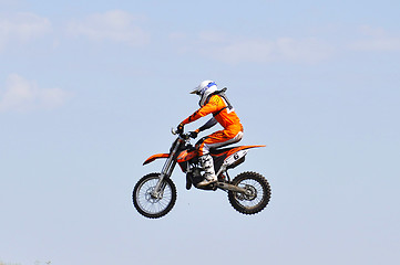 Image showing The motorcyclist on the motorcycle carries out a jump against th