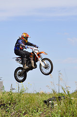 Image showing The motorcyclist on the motorcycle carries out a jump against th