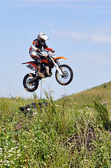 Image showing The motorcyclist on the motorcycle carries out a jump against th