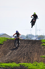 Image showing Motorcyclists on motorcycles participate in cross-country race.