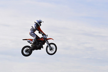 Image showing The motorcyclist on the motorcycle in a jump against the sky.