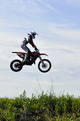 Image showing The motorcyclist on the motorcycle in a jump against the sky.