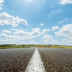 Image showing white line on asphalt road under sky with sun and clouds