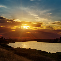 Image showing dramatic orange sunset and river