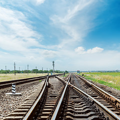 Image showing crossing of railroad under cloudy sky