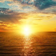 Image showing bright orange sunset over sea