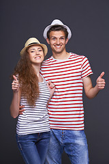 Image showing Young casual couple giving thumbs up