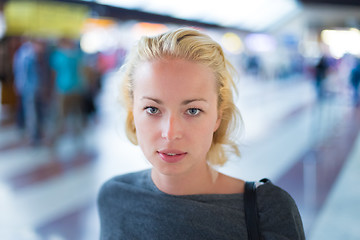 Image showing Young woman on platform of railway station.