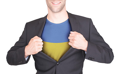 Image showing Businessman opening suit to reveal shirt with flag