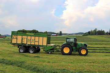 Image showing John Deere 6210R Tractor and Full Krone MX 350 GL Forage Wagon