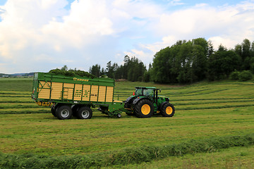 Image showing John Deere 6210R Tractor and Full Krone MX 350 GL Forage Wagon