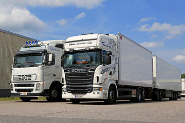 Image showing White Scania R560 and Volvo FH Full Trailer Trucks