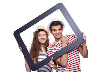 Image showing Happy couple looking through tablet frame