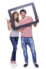 Image showing Happy couple looking through tablet frame