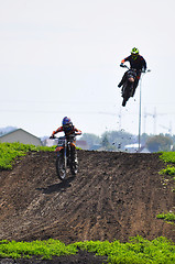 Image showing Race on a cross-country terrain. Motorcyclists on motorcycles ca