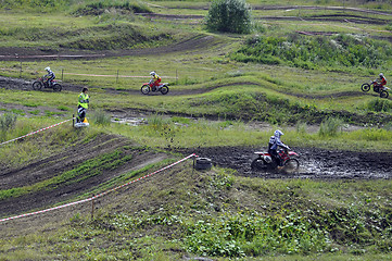 Image showing Motorcyclists on motorcycles participate in cross-country race.