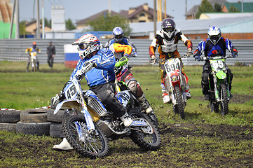 Image showing Cross-country race. Motorcyclists on motorcycles enter turn.