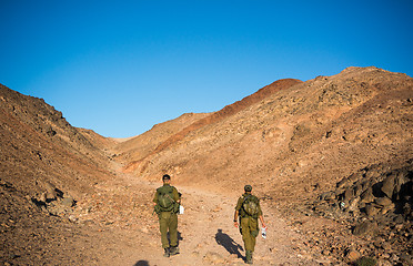 Image showing Soldiers patrol in desert