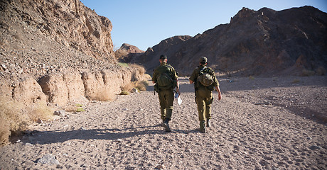 Image showing Soldiers patrol in desert