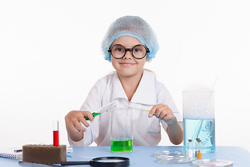 Image showing Girl mixes the liquid