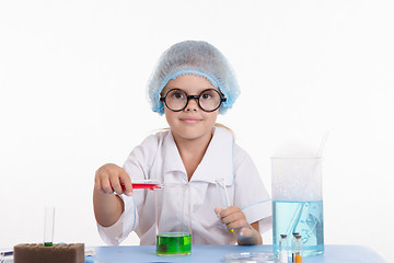 Image showing Trainee pouring liquid in a flask