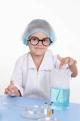 Image showing Girl chemist flask with foam