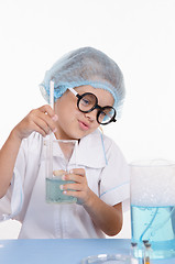 Image showing Girl chemist prevents the liquid in flask