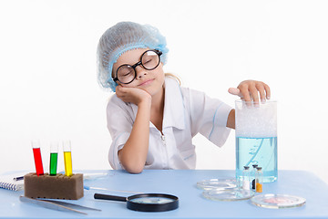 Image showing Girl chemist asleep at the table